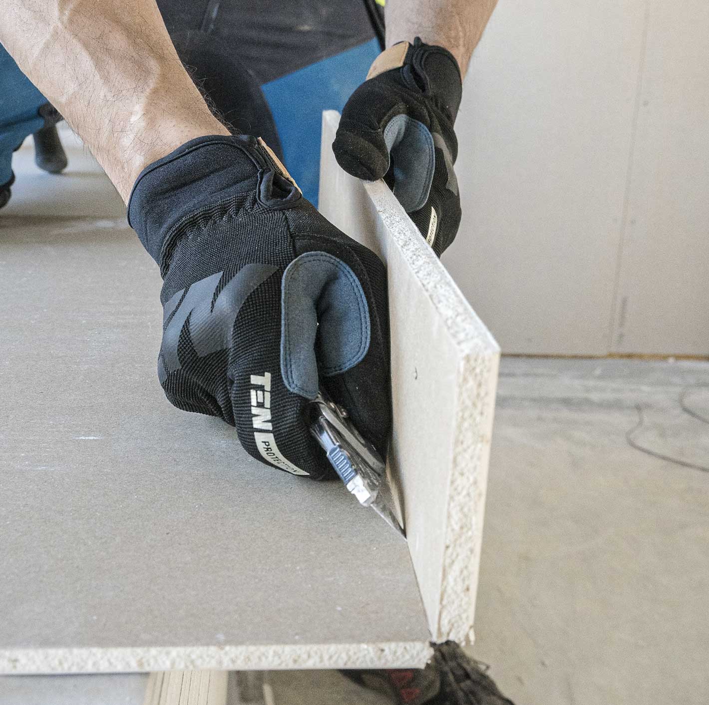 Plaster is being cut out to accommodate both insulation and subsequent plastering for home improvement.